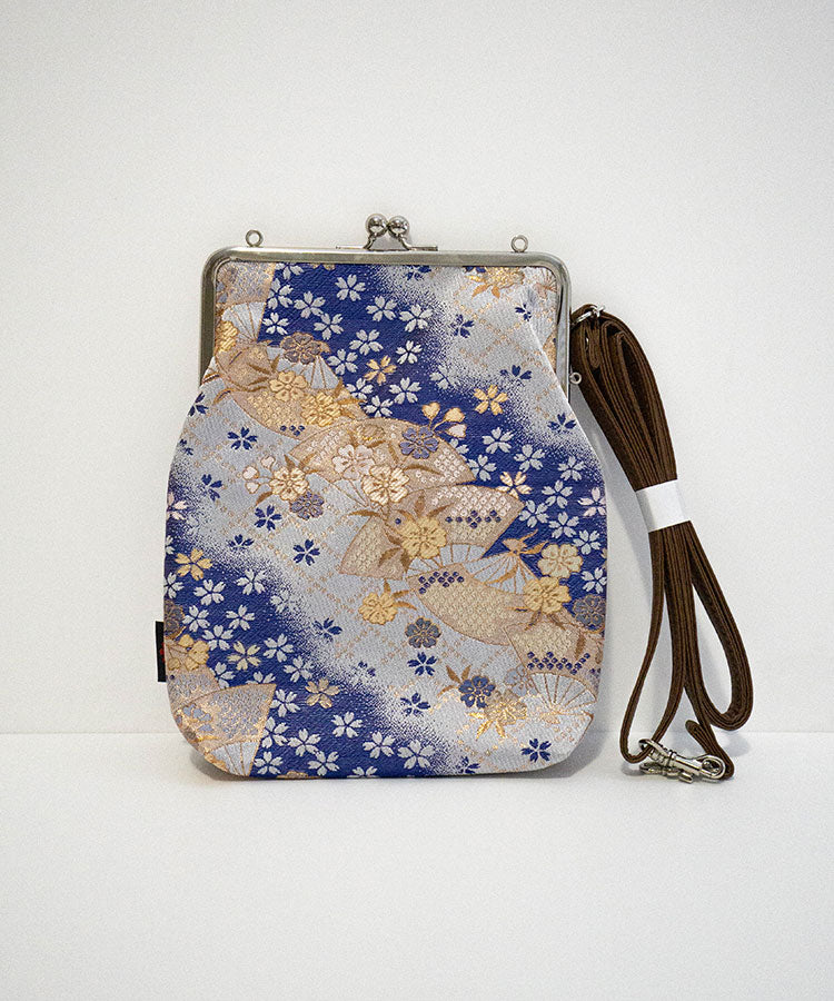 Floral patterned pouch with a strap on a white background