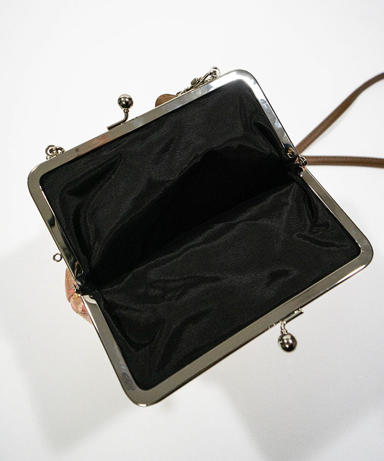 Open handbag with black interior on a white background