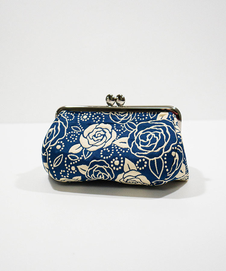 Blue clutch bag with white rose pattern on a white background