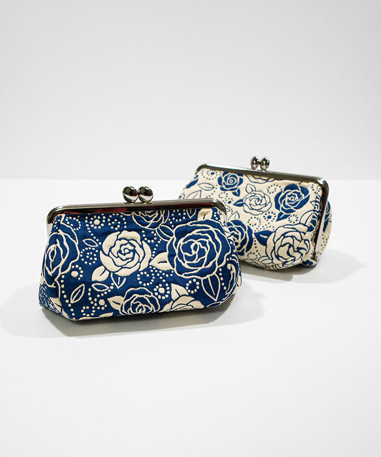 Two fabric pouches with blue floral patterns on a white background
