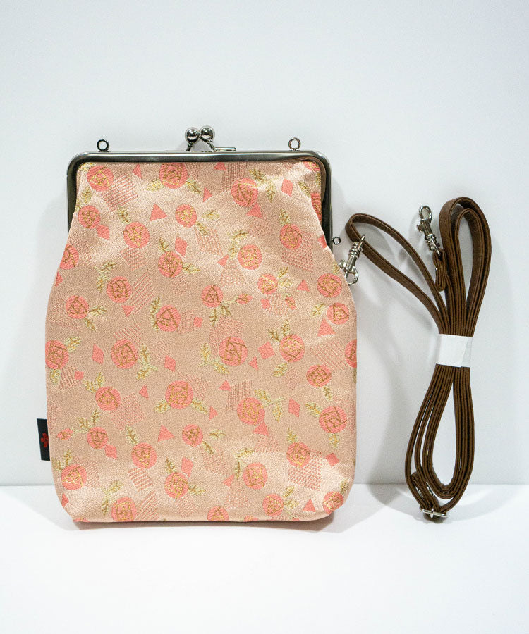Floral-patterned bag with a brown strap on a white background